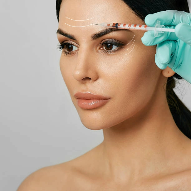 Patient receiving forehead filler treatment at ATOS Medical Center