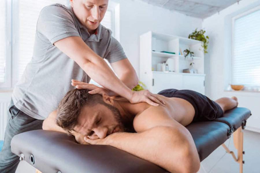 Therapist assisting patient with neck pain therapy.