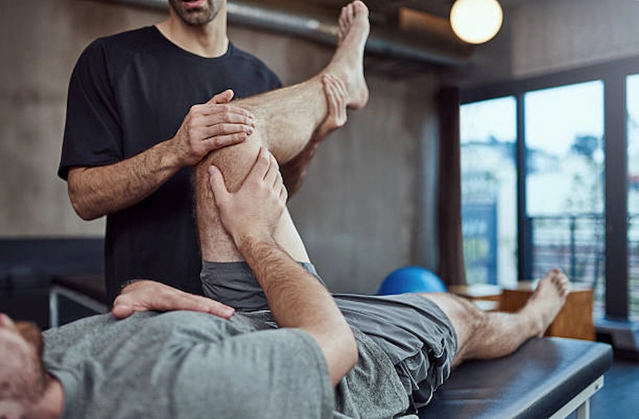 Athlete performing rehabilitation exercises in clinic.